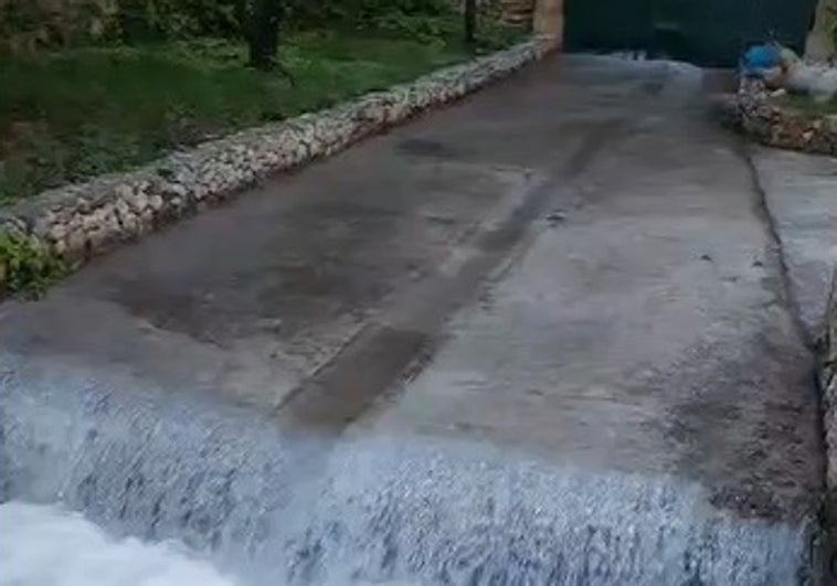 Imagen de la cascada de agua saliendo de la bocamina del Nacimiento del río Guaro.