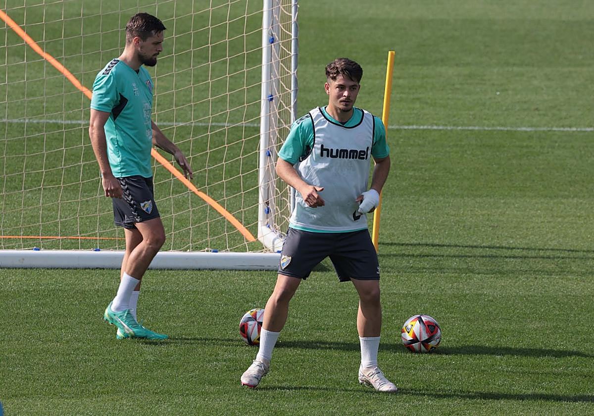 El jugador del Málaga Dani Lorenzo en el entrenamiento de este jueves en La Rosaleda. Al fondo, Genaro.