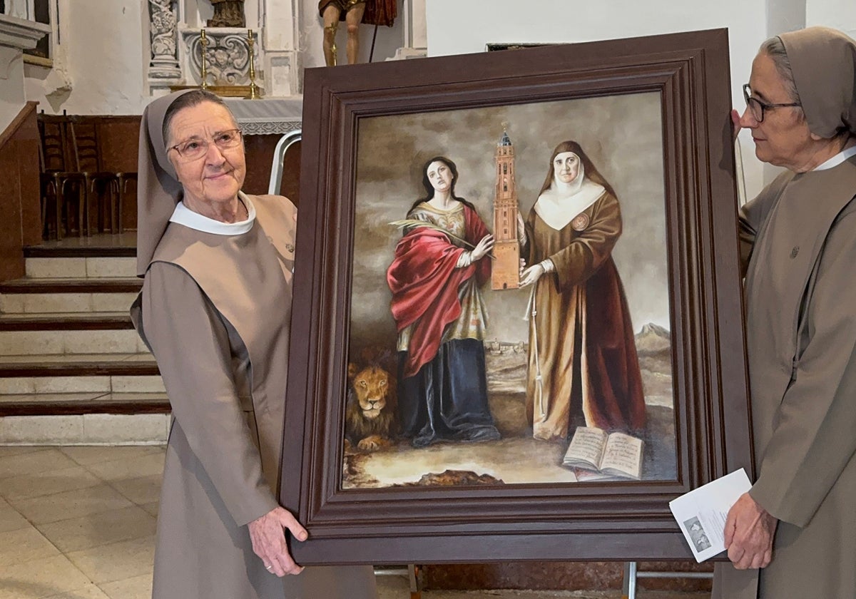 Eva Escobar pinta un cuadro de Santa Eufemia y Madre Carmen para La Victoria de Antequera