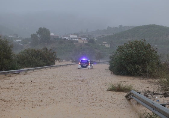 Todoterreno de la Guardia Civil en medio de una carretera inundada en Álora.