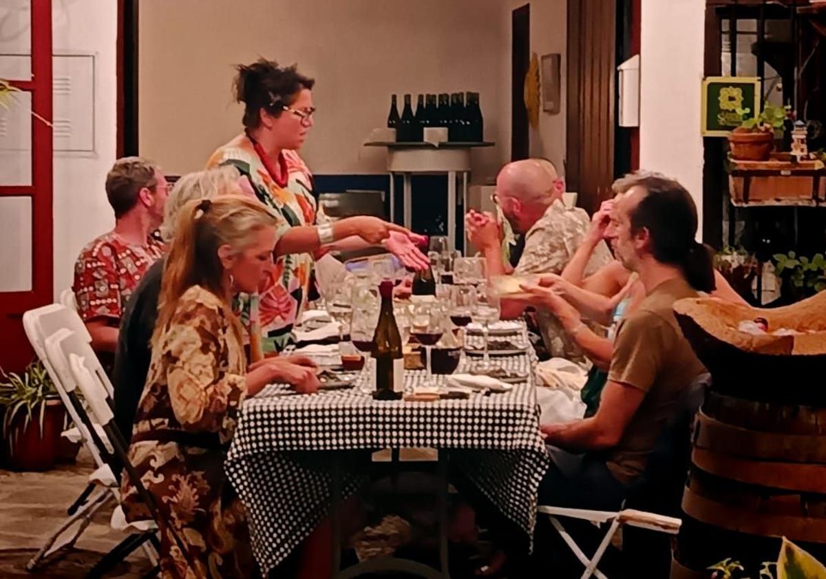 Imagen principal - El anfitrión sólo suele trabajar con grupos pequeños. Un grupo de turistas norteamericanos disfrutan del almuerzo. Pepe Verdugo junto a vinos de su propia bodega, 28 Metros Cuadrados