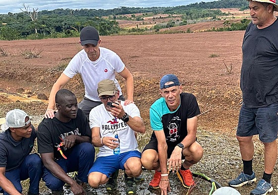 Francisco Martín, con una botella de agua, junto a varios integrantes de la ONG y vecinos del pueblo guineano.