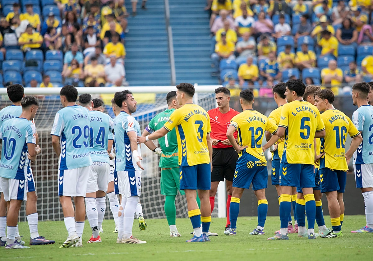 Los jugadores del Málaga y de Las Palmas aguardan a la revisión desde la Sala VOR de una jugada polémica.