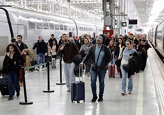 Viajeros bajan de un tren de alta velocidad camino de la estación en Málaga.