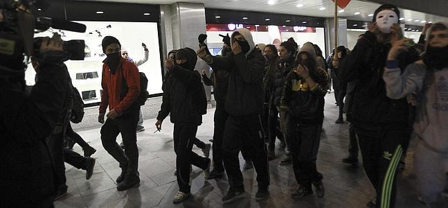 Varios jóvenes a su paso por la calle del Carmen de Madrid. / Efe