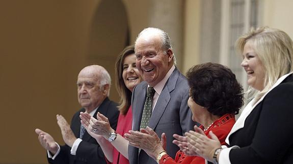 El Rey Juan Carlos, junto a la ministra de Empleo y Seguridad Social, Fátima Báñez (2i), entre otros, es aplaudido durante el acto conmemorativo del XXV aniversario de Seniors Españoles para la Cooperación Técnica. 