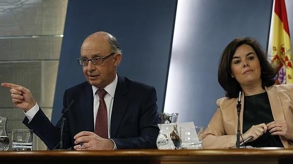 Cristóbal Montoro (i.) y Soraya Sáenz de Santamaría.