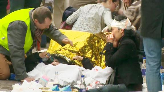 Un sanitario ayuda a una víctimas del atentado en el metro de Maalbeek, Bruselas.