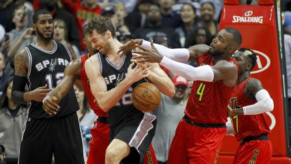 Pau Gasol pelea por un balón con Paul Millsap. 