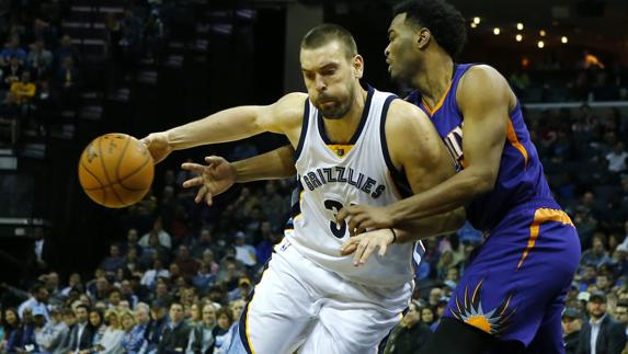 Marc Gasol de los Grizzlies disputa el balón con T.J. Warren de los Suns.