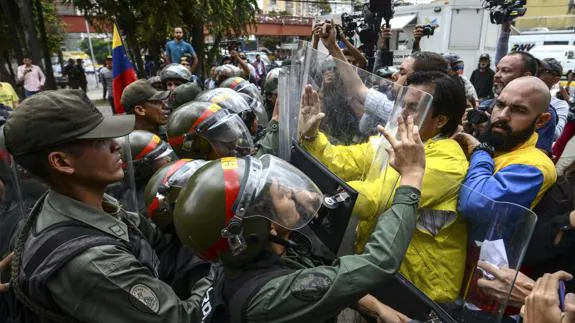 Partidarios de la oposición se enfrentan a la Guardia Nacional venezolana.