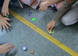 Niños juegan con los populares 'tazos' en una clase de Educación Física. SUR