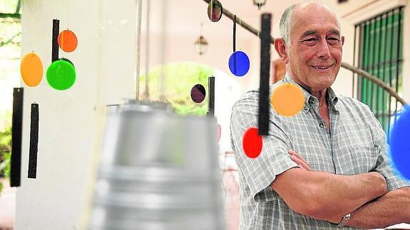 Ángel Cañizares, junto a una de sus esculturas móviles de colores en su casa de El Lagar. 