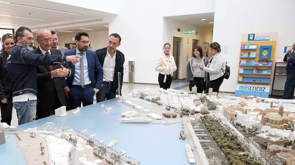 De la Torre, Banderas y Pomares comentan la maqueta de la ciudad que está en el vestíbulo de la Gerencia de Urbanismo