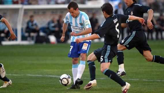Duda toca el balón ante Gago y Sergio Ramos en 2010.