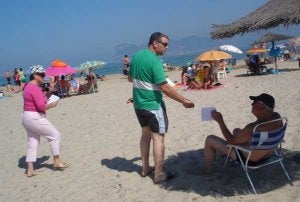 Jorge Romero, candidato andalucista a la Alcaldía de Los Barrios, entrega la información a un usuario de la playa de Palmones. ::
SUR