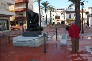 Un vecino lee la placa que acompaña a la escultura 'Mavi'. ::
S. V.