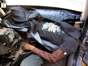 Imagen facilitada por la Guardia Civil con el joven en el salpicadero. ::
SUR