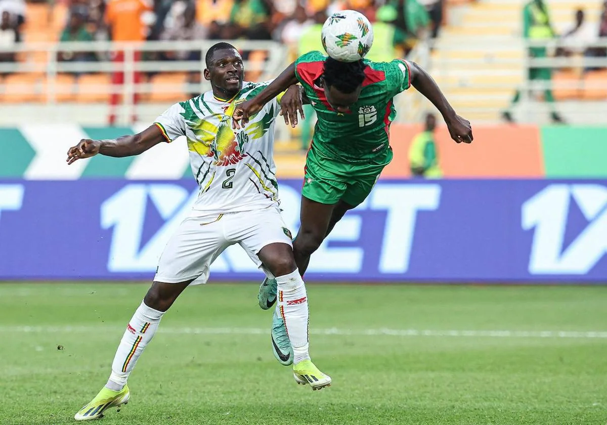 Hamari Traoré pugna por un balón con un jugador de Burkina Faso.