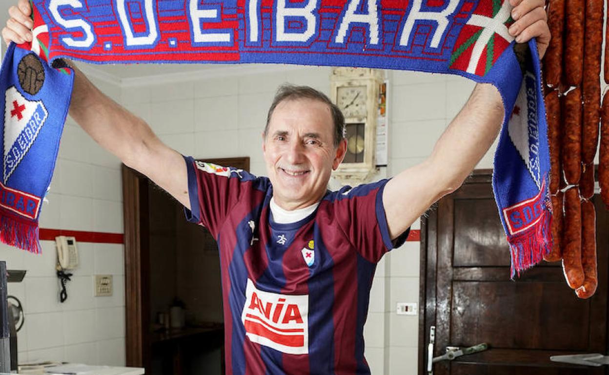 Garmendia posa con una bufanda y una camiseta del Eibar en su carnicería. 