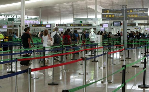 Pasajeros en los accesos de control del aeropuerto de El Prat.