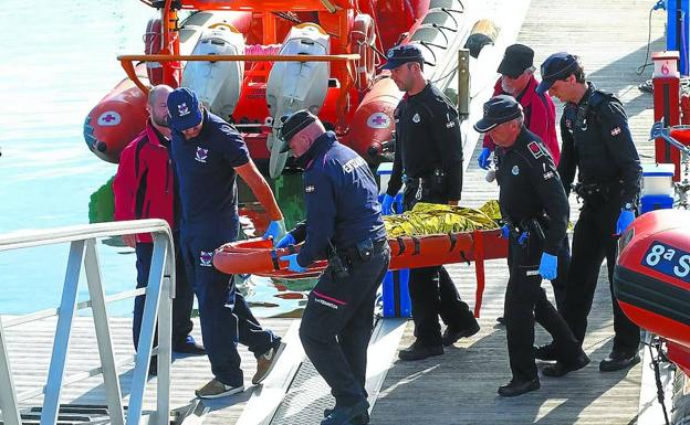 Agentes de la Ertzaintza trasladan el cuerpo del joven fallecido, ayer en la base de Cruz Roja en Hondarribia.