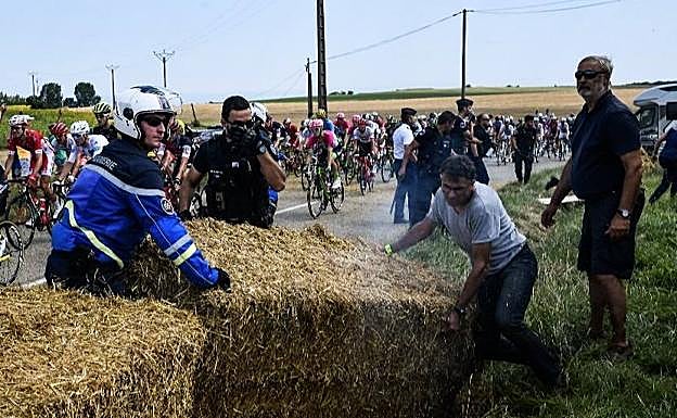 La polícia retira los fardos de paja colocados en la protesta. 
