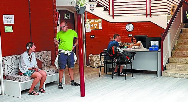 Acogida. Varios peregrinos y la hospitalera, en la recepción del nuevo albergue de Irun, que abrió sus puertas hoy hace un mes en la calle Lesaka.

