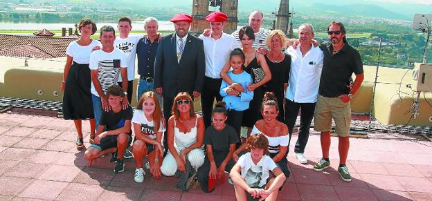 Ion Areitio posa con sus familiares y el alcalde Txomin Sagarzazu en la majestuosa terraza del Parador, con el campanario de la parroquia al fondo.