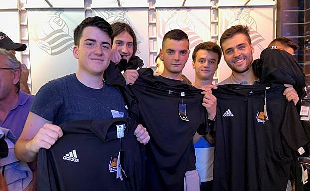 Borja, a la derecha, posa con sus amigos y los productos adquiridos. 