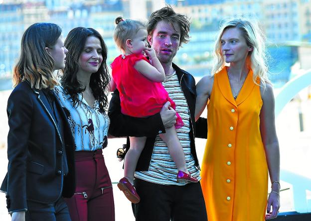 Mia Goth, Juliette Binoche, Robert Pattinson con una niña en brazos y Agata Buzek, ayer de sesión fotográfica en el Kursaal. 