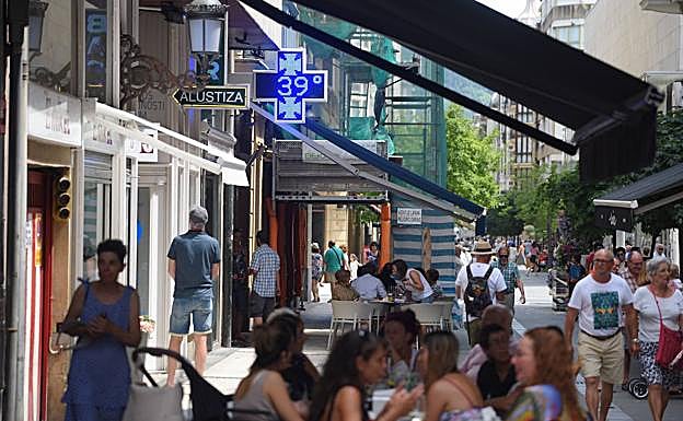 En una terraza, bajo un toldo y una bebida refrescante, una fórmula para hacer frente a los 39 grados que se midieron ayer en Donostia .
