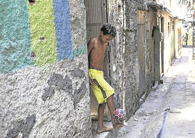 Imagen secundaria 1 - Postales.  Soldados brasileños patrullando por Rocinha. Un niño jugando al balón. Vista de la favela. 