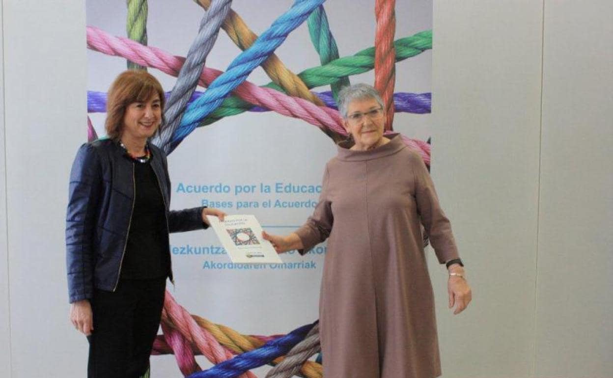 Cristina Uriarte y Nélida Zaitegi sostienen el documento con las bases para el acuerdo en la Educación. 