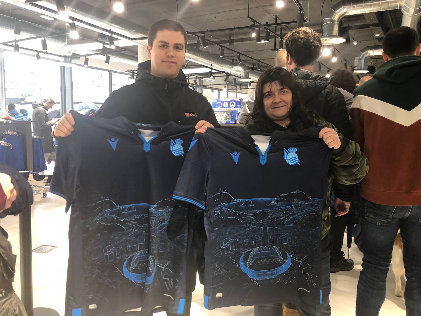 Cientos de aficionados realistas han esperado durante varias horas bajo la lluvia en las tiendas de la Real Sociedad para comprar una elástica
