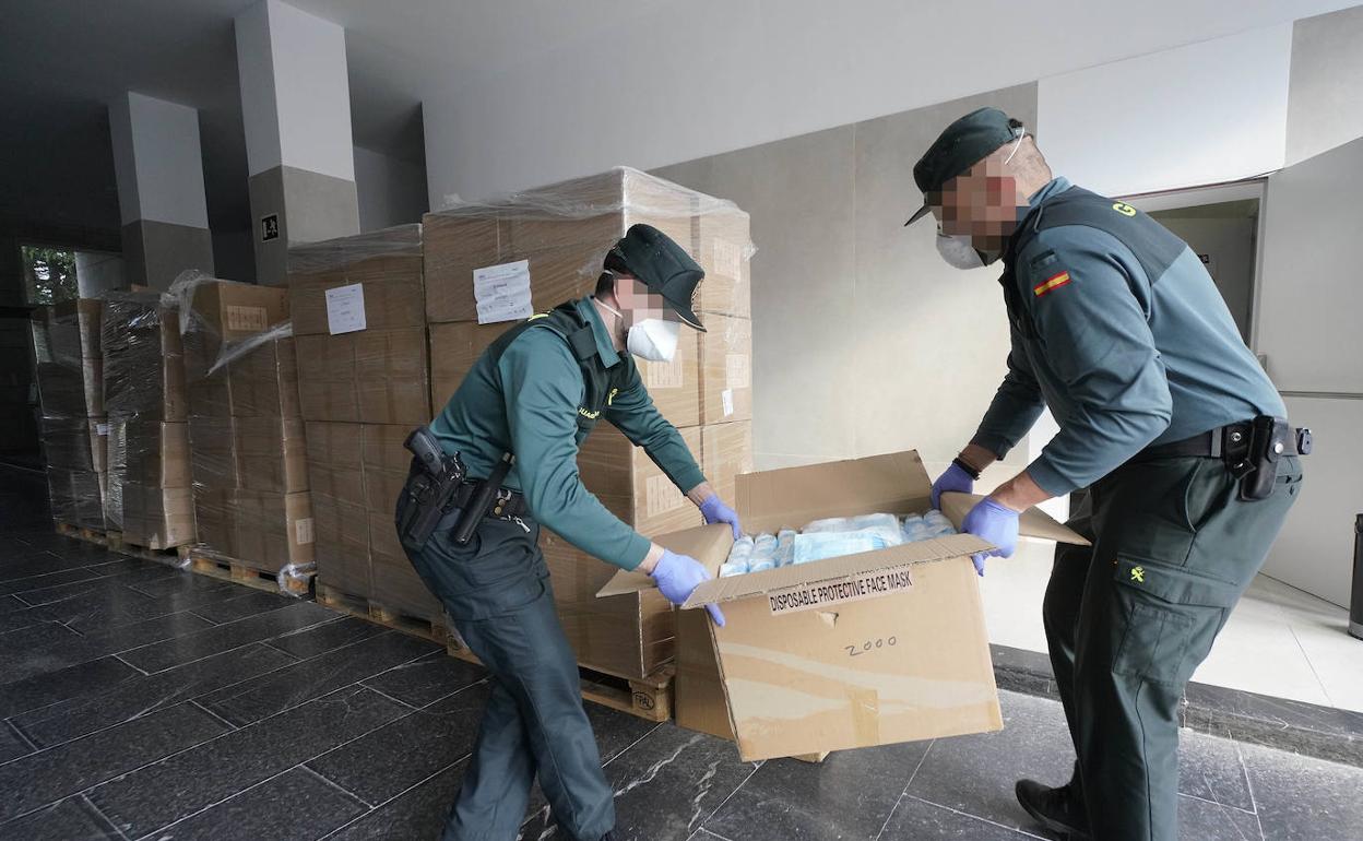 Dos agentes de la Guardia Civil manipulan una de las cajas con mascarillas higiénicas que recibió ayer la Subdelegación de Gobierno de Gipuzkoa. 