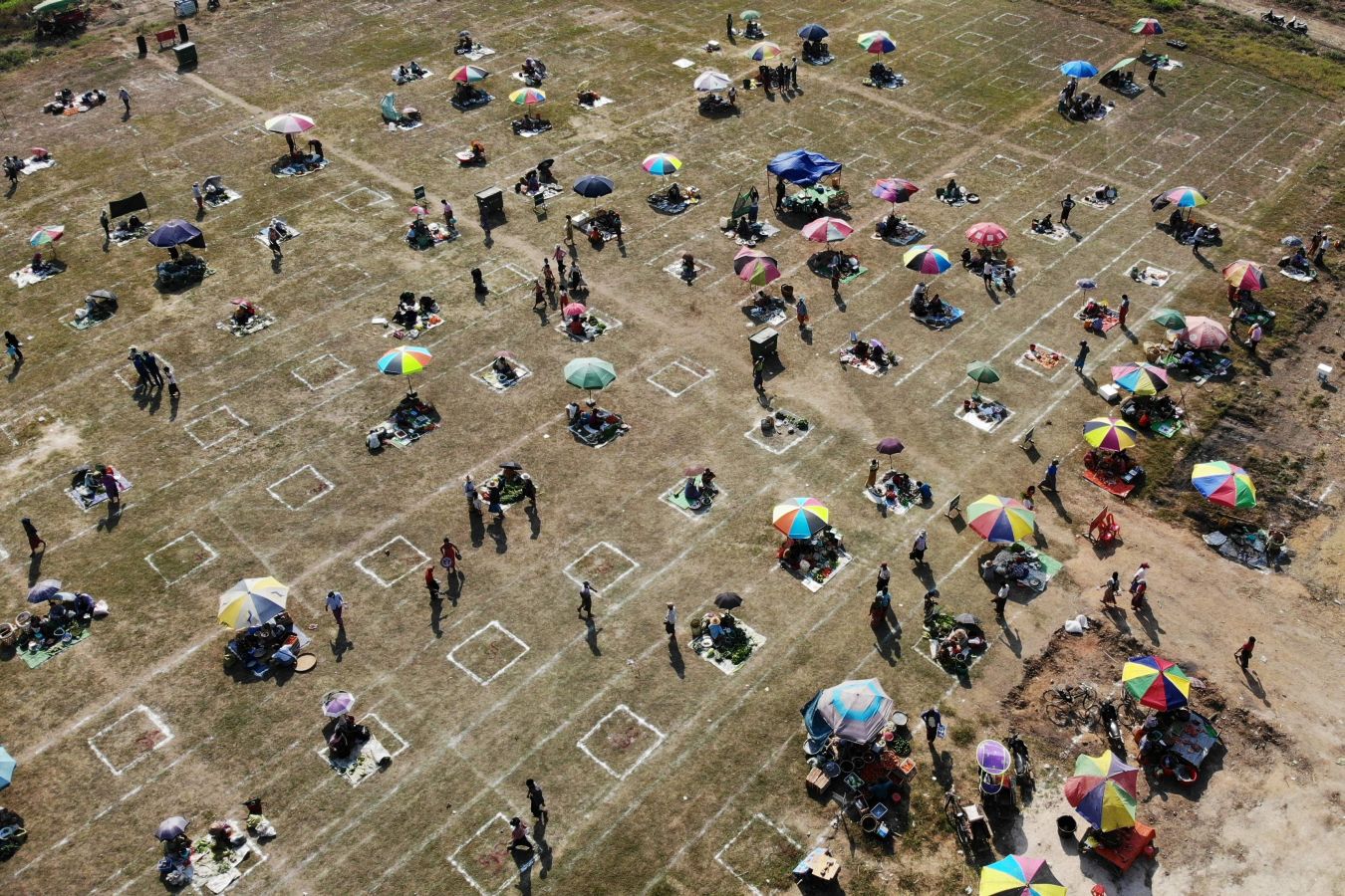 Una localidad de Myanmar ha decido utilizar un campo de fútbol para convertirlo en un gran mercado al aire libre. Sobre el maltrecho césped se han pintado nuevas líneas que ya no dibujan el centro del terreno de juego o las áreas, sino las distancias de seguridad para evitar la propagación del Covid-19.