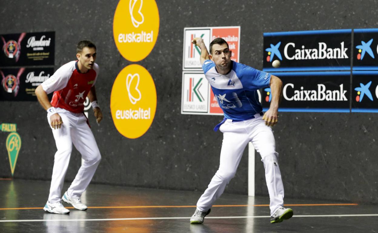 Jaka se dispone a golpear la pelota ante la mirada de Urrutikoetxea.