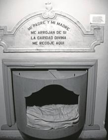 Imagen secundaria 2 - Nodrizas, madres e Hijas de la Caridad con el director Jesús Alústiza. Para evitar abandonos en la vía pública o infanticidios, crearon estos cilindros giratorios. Desde el exterior la madre colocaba al bebé, el torno giraba y activaba una alarma para que la criatura fuera recogida en el interior. Hubo en Donostia, Tolosa, Azpeitia y Bergara.