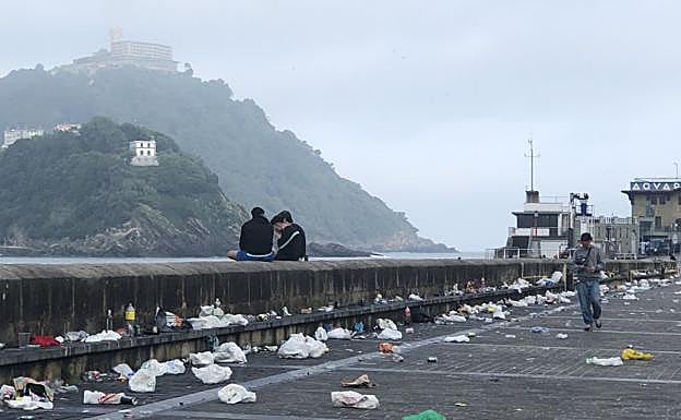 Galería. Los restos de basura se acumulaban en el espigón del puerto donostiarra a primera hora de este domingo