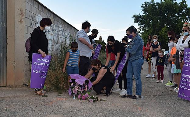 los familiares de la víctima colocan un ramo de flores en el lugar del asesinato..