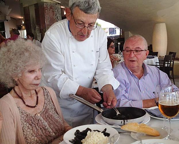 José Juan Castillo sirve un plato de chipirones en su tinta a la Duquesa de Alba ante la mirada de Juan Mari Arzak.