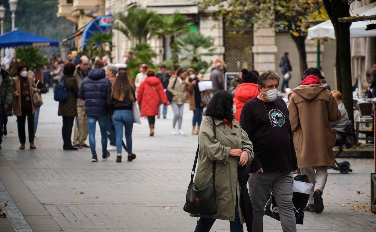 Paseantes con mascarilla por el Boulevard donostiarra