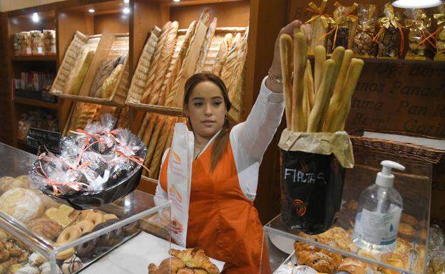 Una joven sin mascarilla atiende en una panadería de Ogi Berri en Donostia.