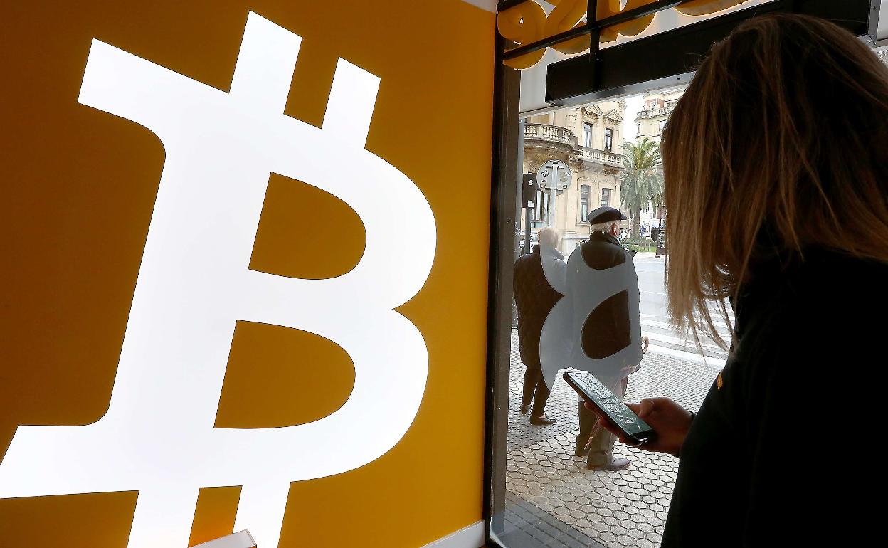 Una usuaria se informa del valor de una divisa digital en el establecimiento que se encuentra en el Boulevard donostiarra. 