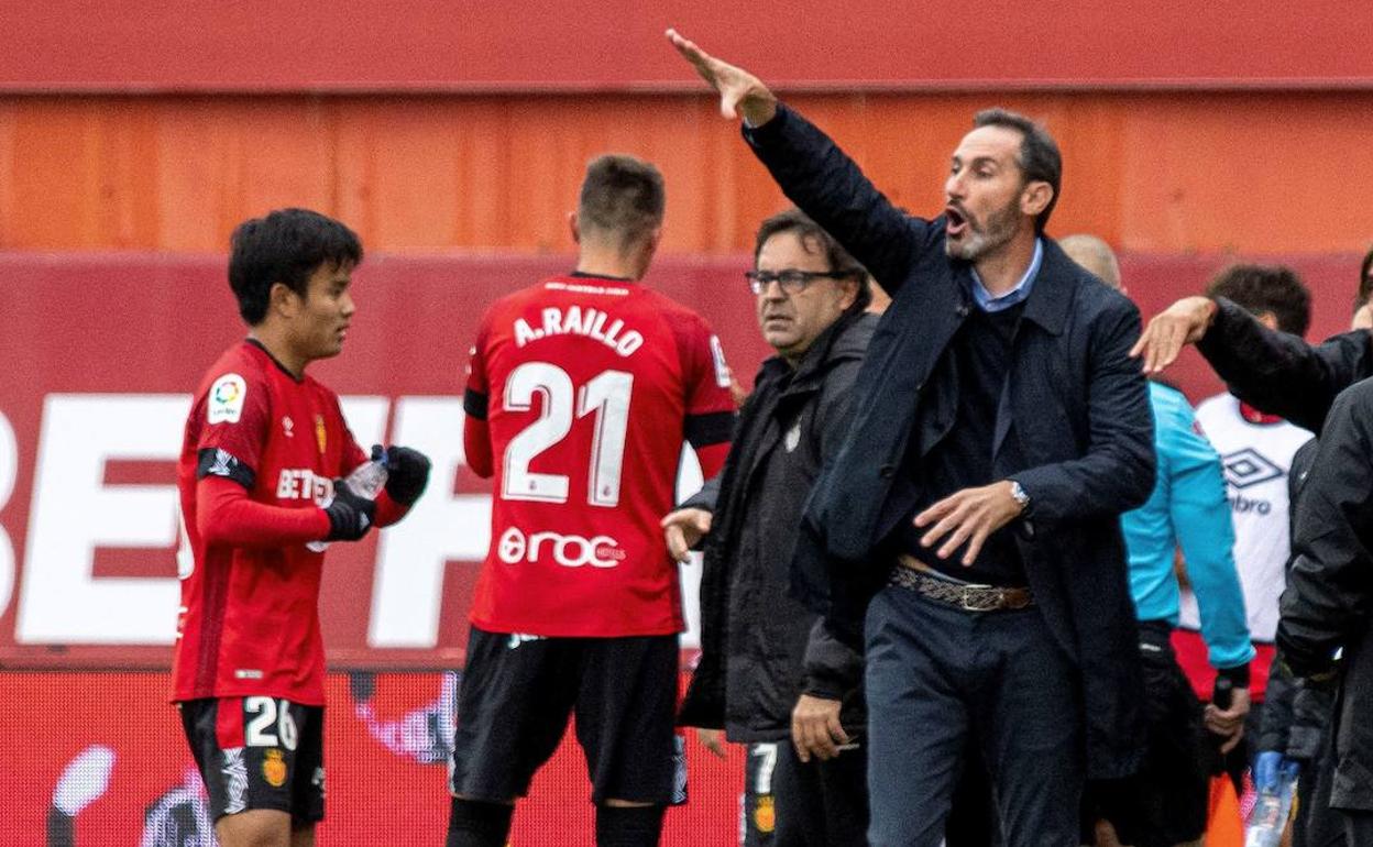 Vicente Moreno realiza unas indicaciones durante su estancia en el Mallorca, mientras Kubo se acerca a la banda.