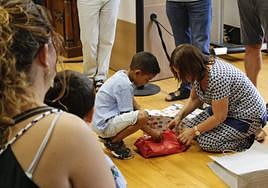 Lansari abre uno de los primeros regalos en su recibimiento.