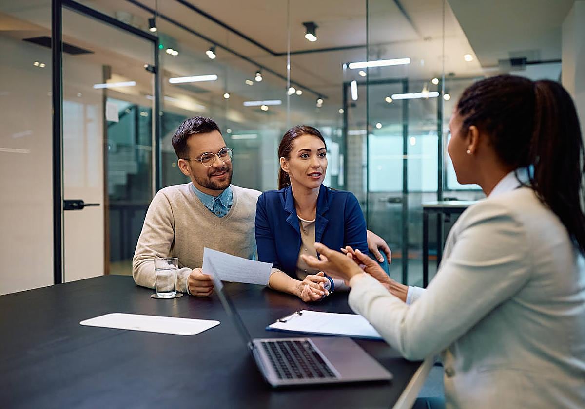 Una pareja realiza una consulta financiera en un banco.