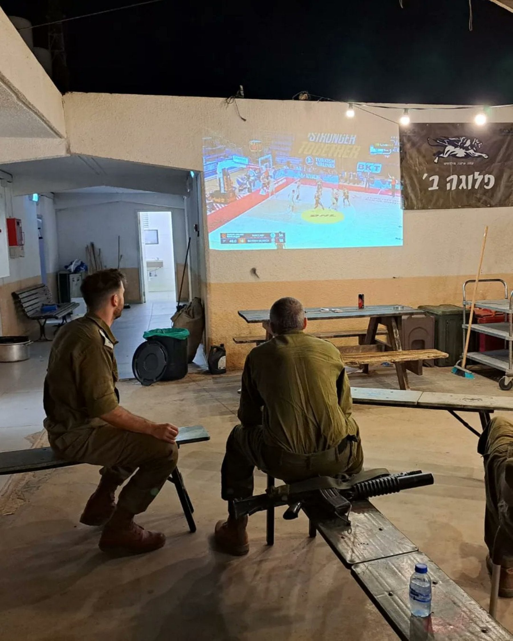 Dos soldados,viendo al Maccabi.