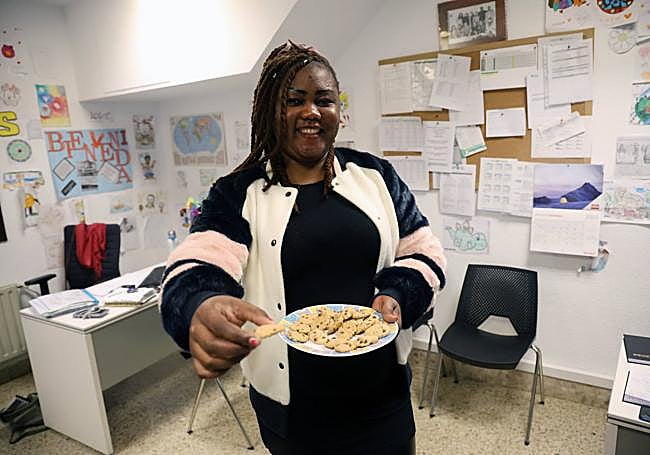 La camerunesa Chrystelle da al fotógrafo una galleta por su cumpleaños.